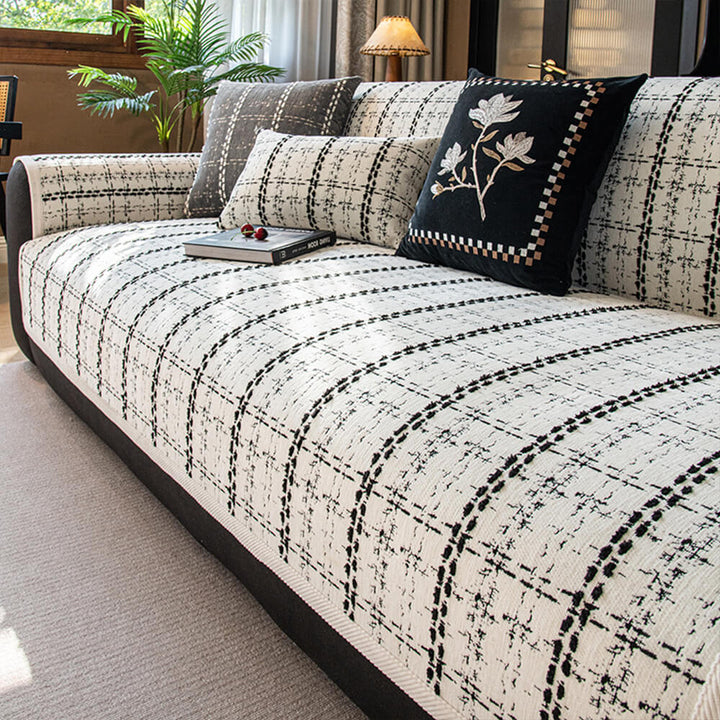Checkered jacquard sofa protector made from soft chenille, offering all-season furniture protection.