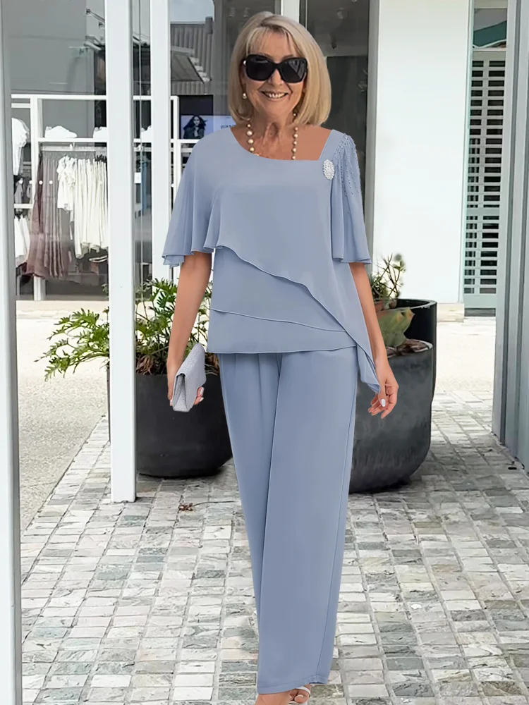 Elegant navy blue women's 2-piece pant set with an asymmetrical top & wide-leg pants, perfect for evening wear.