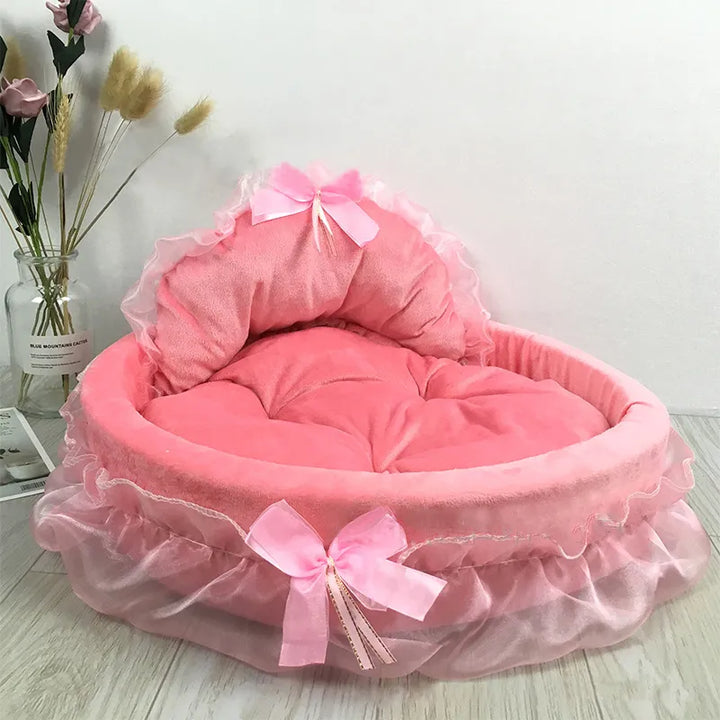 Beautifully crafted cat bed with a prominent tulle ruffle and a cute bow, offering a cozy pet accessory.