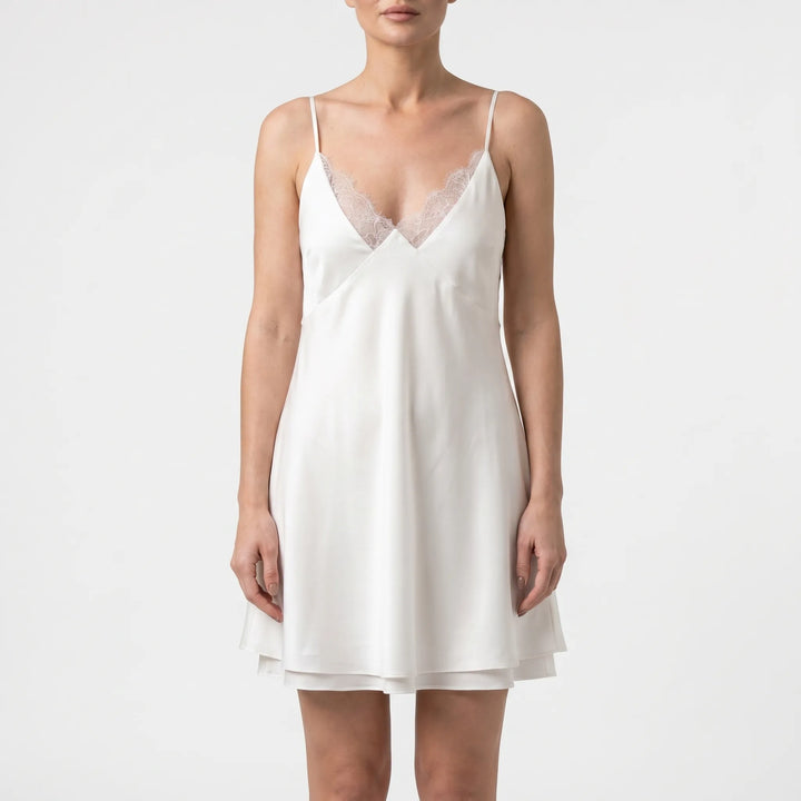 Women's casual A-line white mini dress; stylish backless design with spaghetti straps for summer.