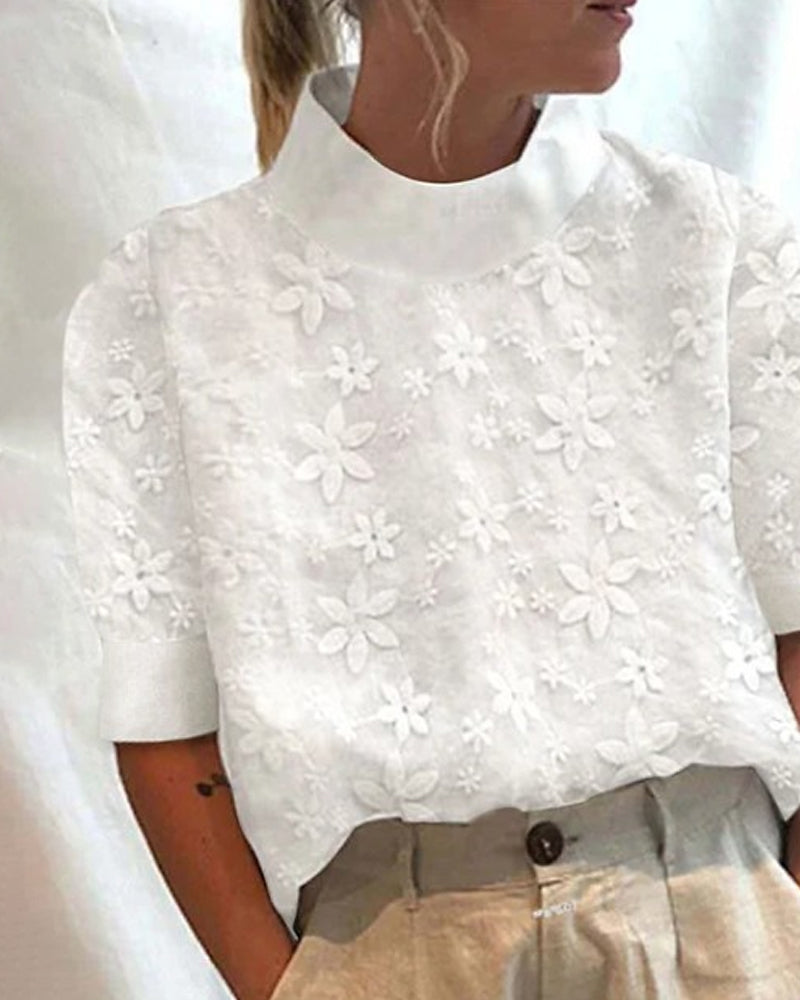 Chic white women's blouse featuring delicate floral embroidery and an elegant stand collar for versatile styling.