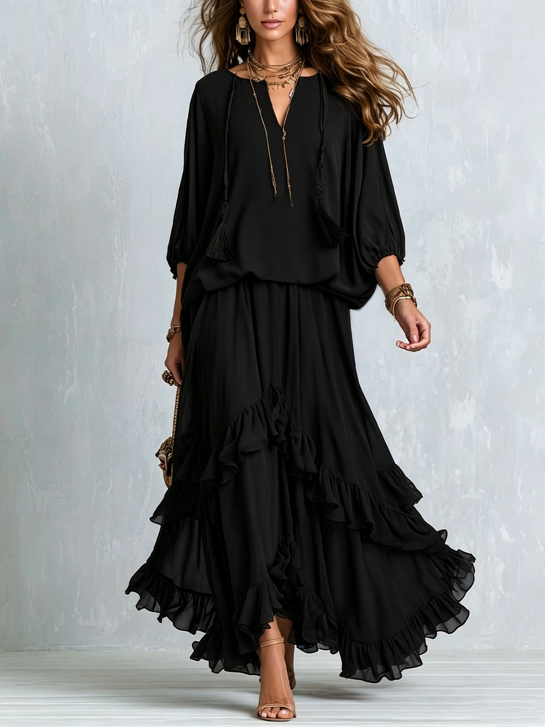 Elegant women's black boho maxi skirt set with a tassel V-neck top & ruffled tiered skirt, perfect for evenings.