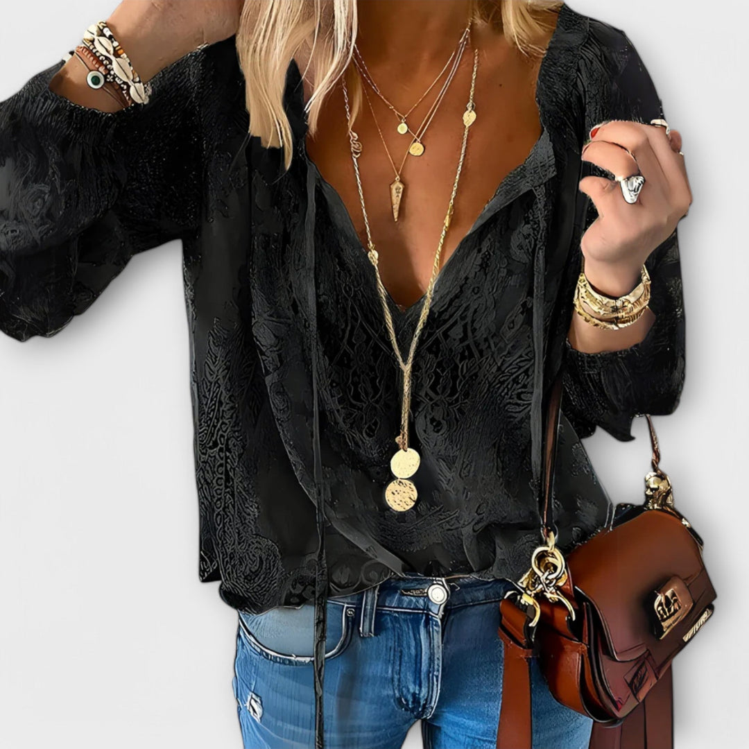 Flowy long-sleeve women's bohemian top with a tie neck, a versatile and chic shirt for spring fashion.