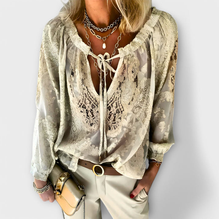 Sophisticated women's blouse featuring a bohemian design, elegant tie neck, and comfortable long sleeves.