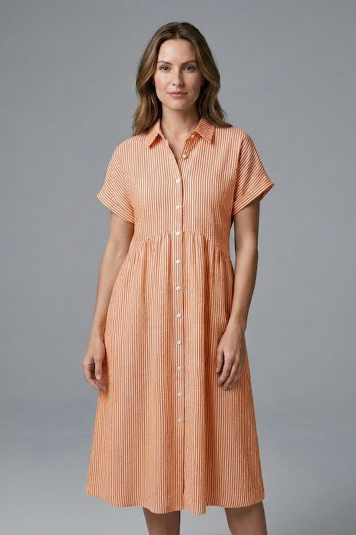 Detail of the stylish buttons and fabric on a women's elegant collared midi dress.