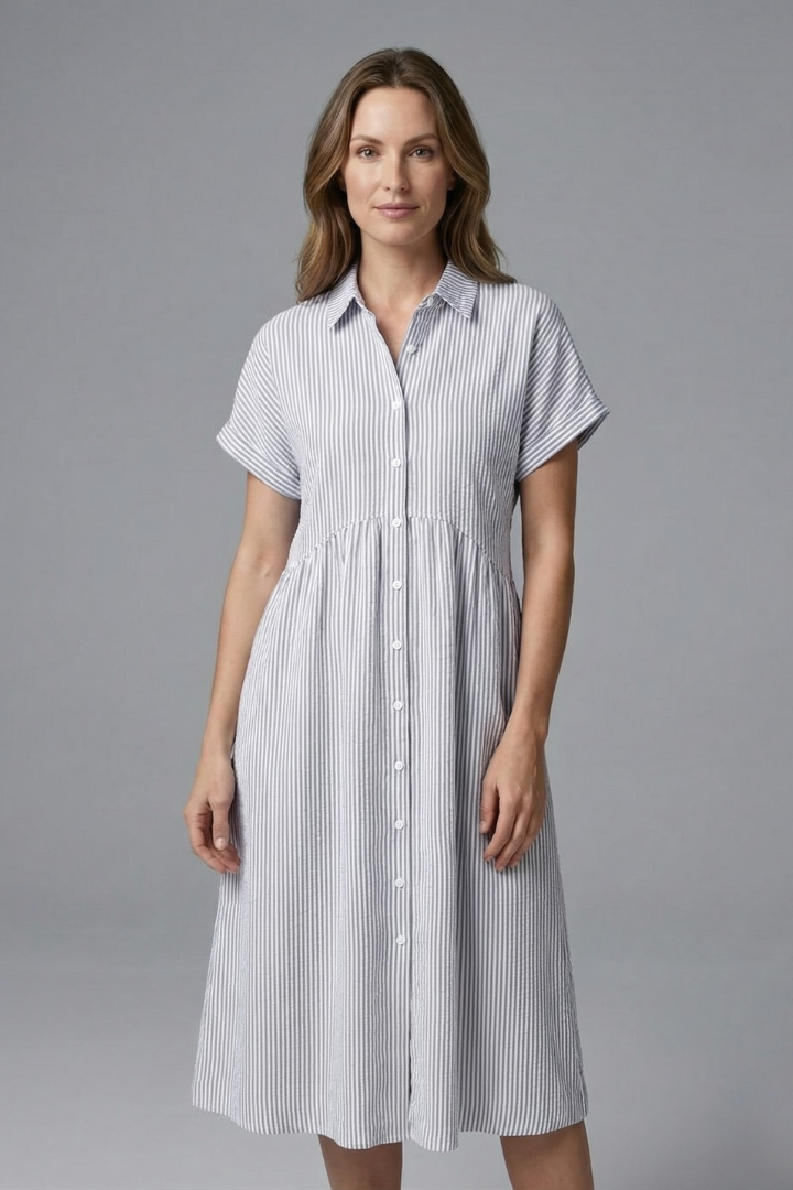 Full shot of a women's long midi dress, collared and button-front, offering an elegant look.
