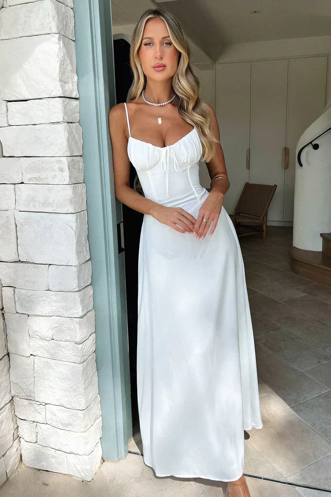 Maxi wedding guest dress with a corset bodice and sweetheart neckline. Ideal for elegant summer events.