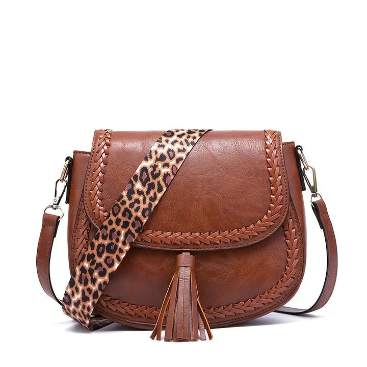 New black women's fashion crossbody bag featuring elegant tassel detail. A chic and stylish everyday purse.