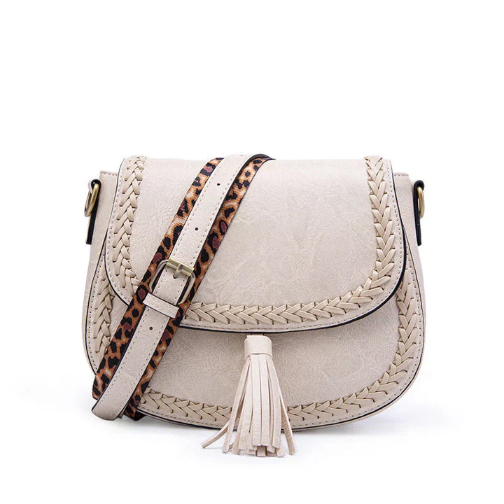 Stylish white women's crossbody bag with elegant tassel detail. Perfect chic accessory for any fashion outfit.