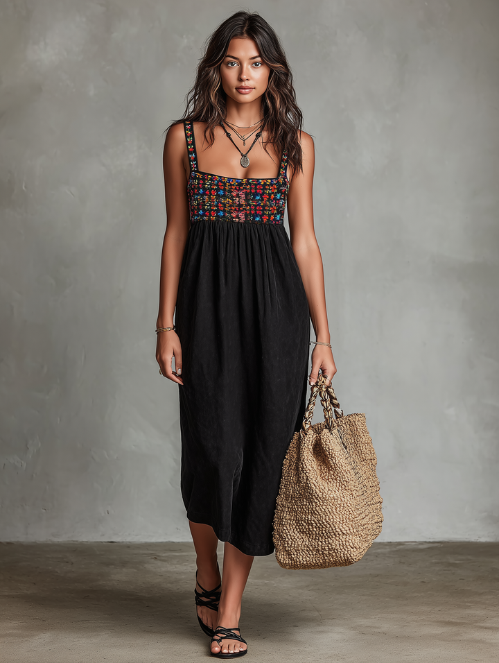 Chic women's embroidered sleeveless midi dress with delicate patterns, offering a breezy, elegant look.