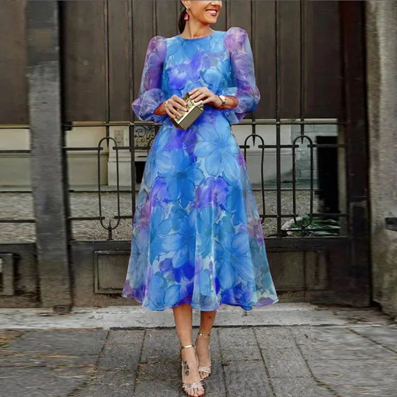 Feminine floral midi wedding guest dress for women with long sleeves. Ideal elegant formal dress for special occasions.