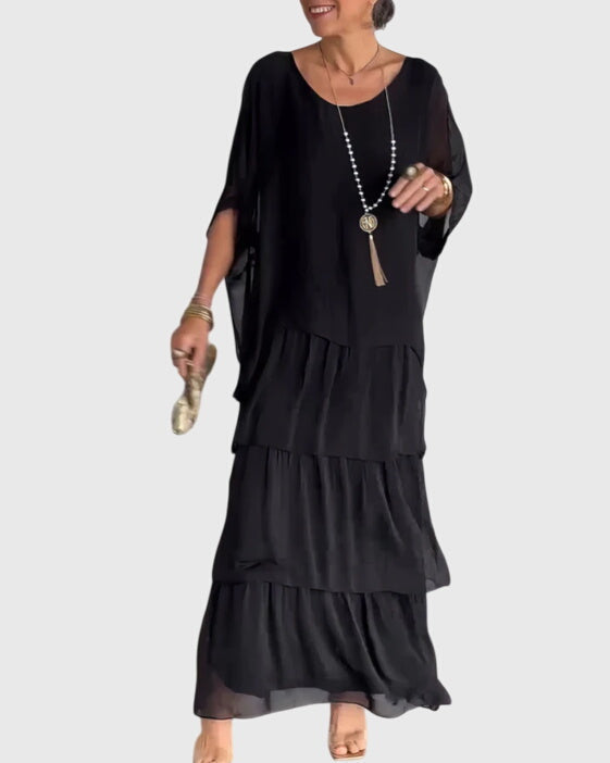 Formal special occasion women's maxi dress with relaxed fit, flowing fabric, and button-up detail.