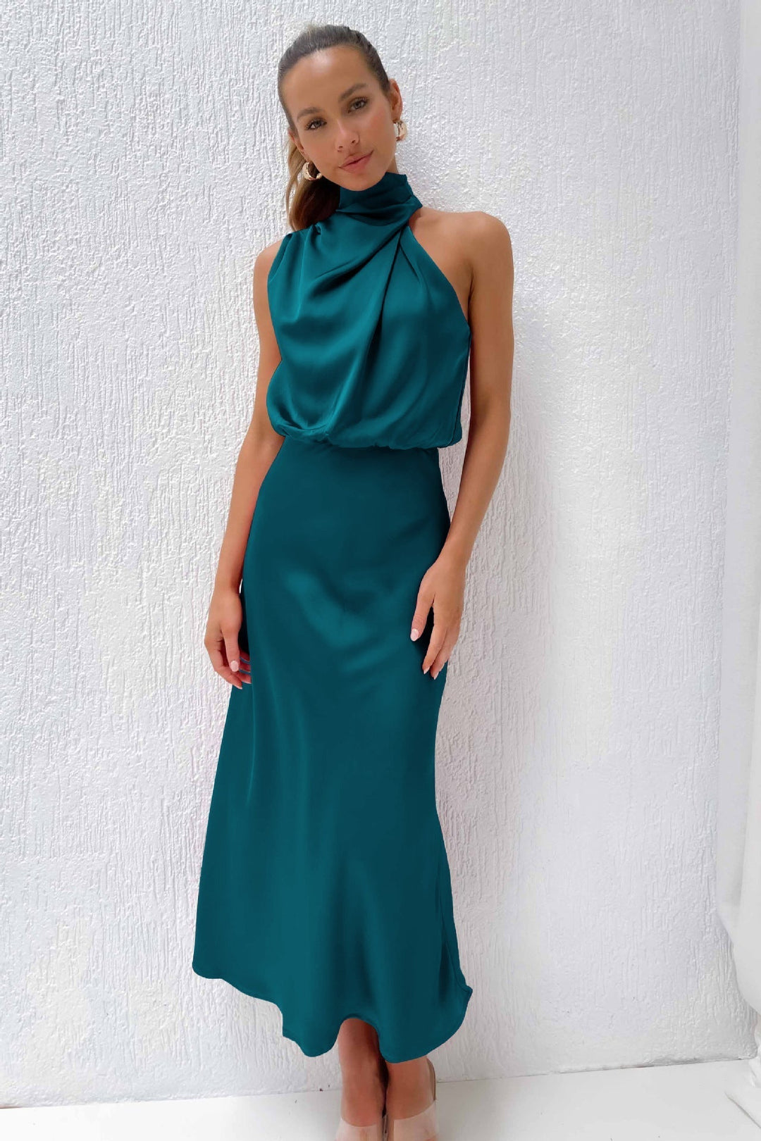 Red carpet style women's halter evening gown, open back, floor-length, sophisticated & flowing design.