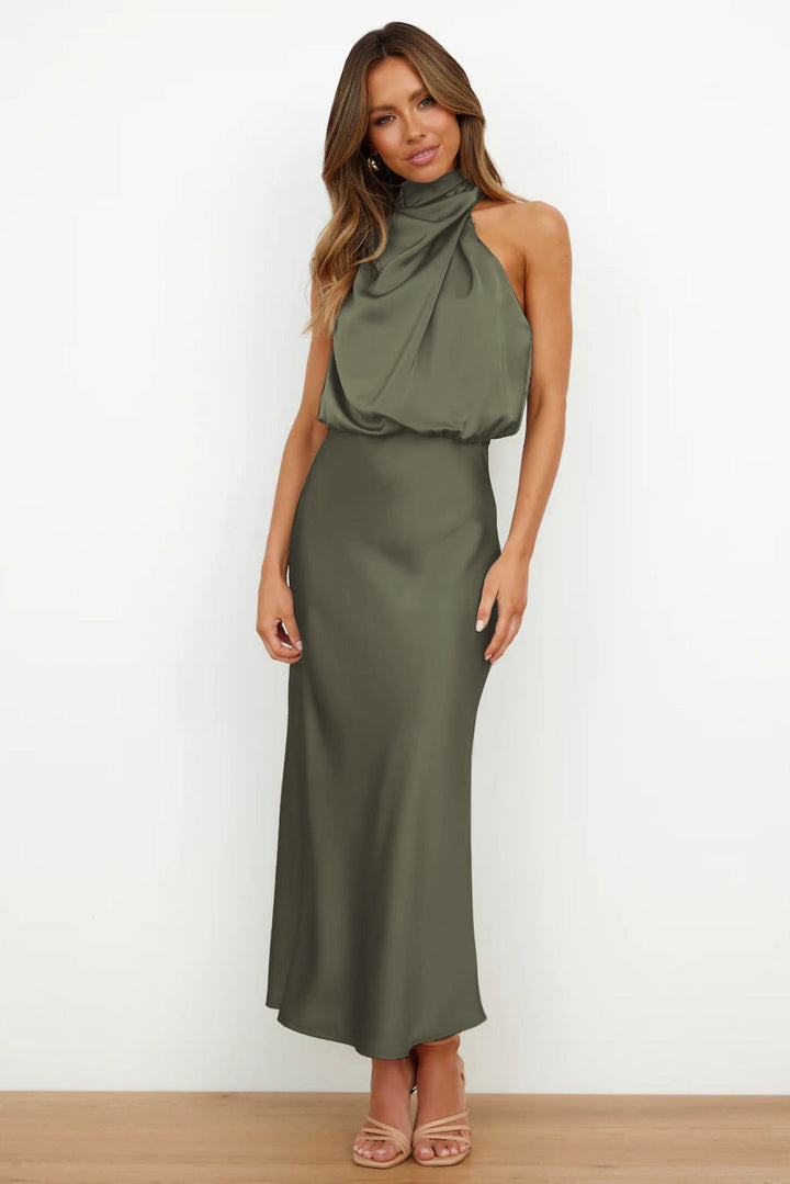 Beautiful open-back women's halter evening gown, floor-length, flowing design for elegant formal events.