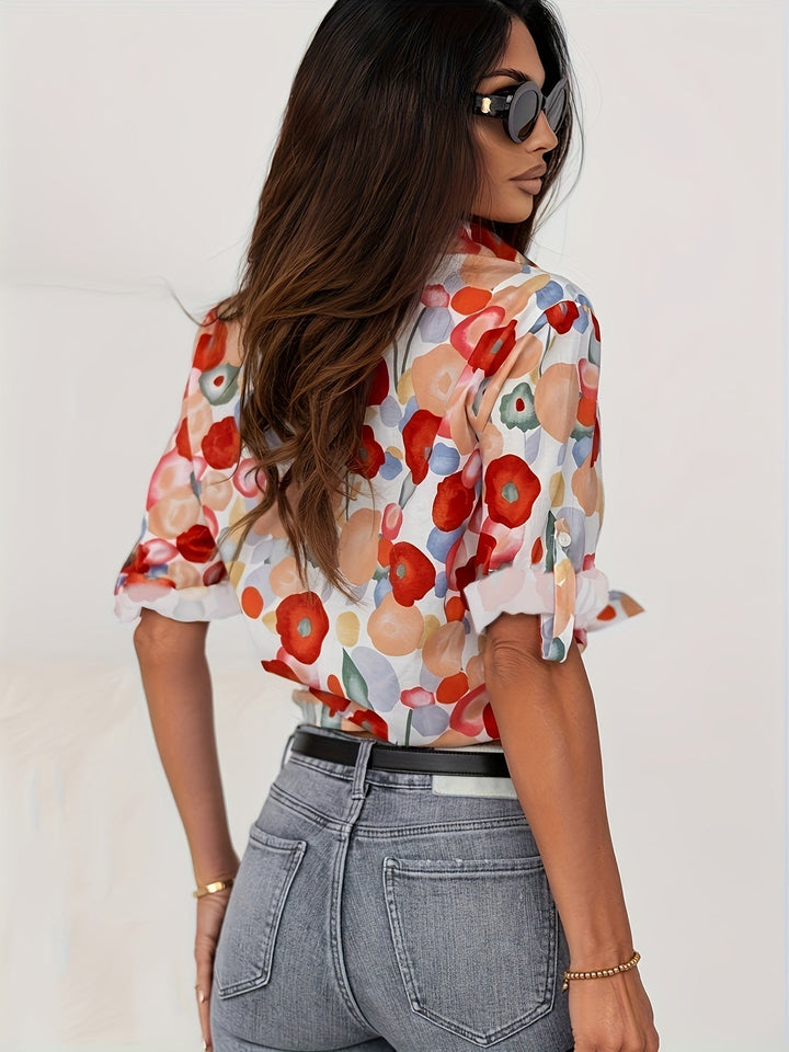 Vibrant floral print women's long-sleeve button-down blouse, artistic design for casual or smart casual.