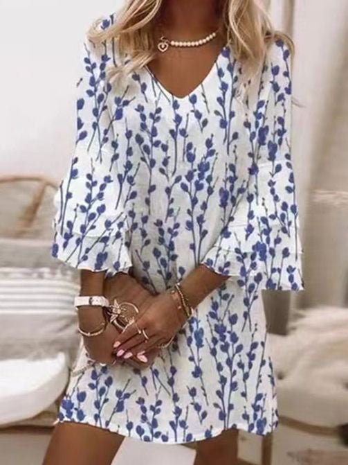 Flowing women's mini dress with an elegant marble swirl print and graceful three-quarter flare sleeves.