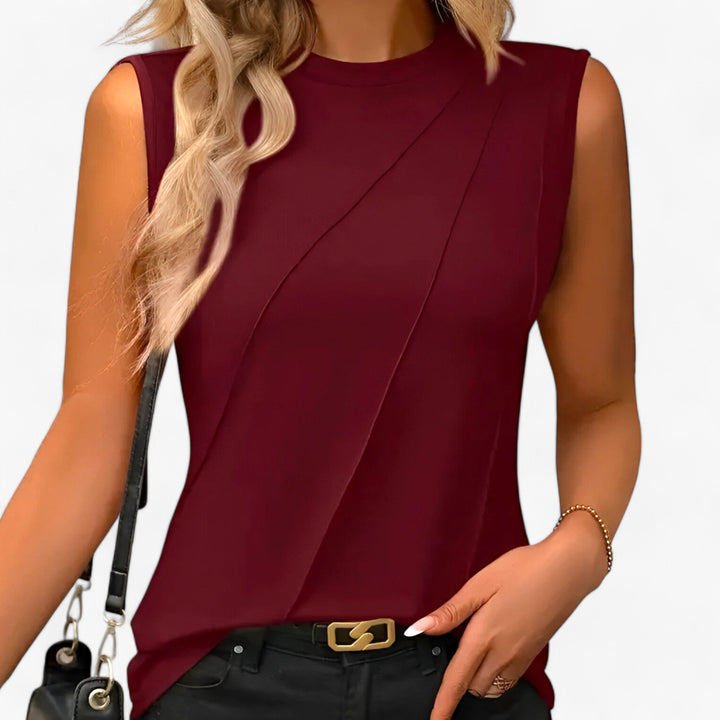 Comfortable women's sleeveless mock neck blouse with a chic draped, relaxed fit, perfect for versatile everyday wear.