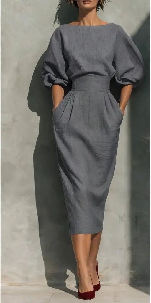 Women's classic pleated midi dress, showcasing elegant lantern sleeves & a sophisticated silhouette.