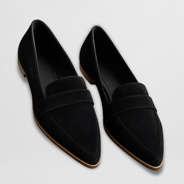 Black women's pointed-toe flat loafers. Stylish and comfortable slip-on shoes for office, casual, or elegant looks.