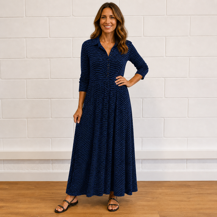 Full-length view of a women's flowy printed button-front maxi dress with long sleeves, perfect for day to night.