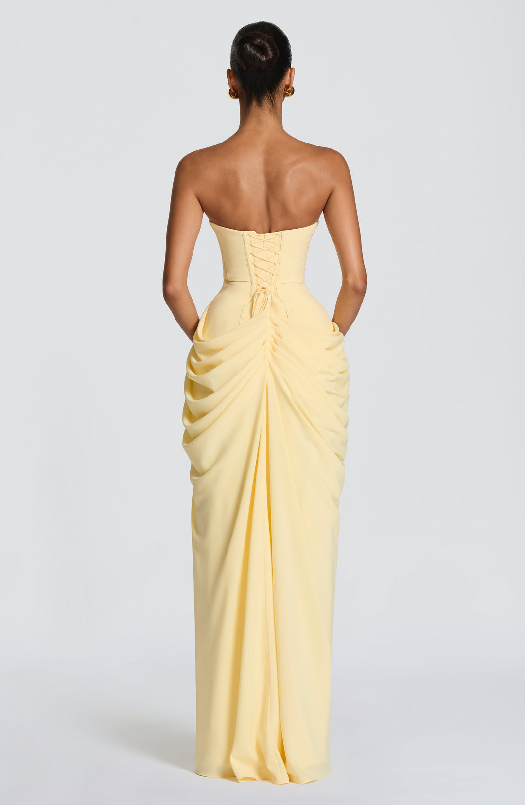 Fashionable women's strapless formal dress, a corset-style maxi gown with a daring high slit for parties.