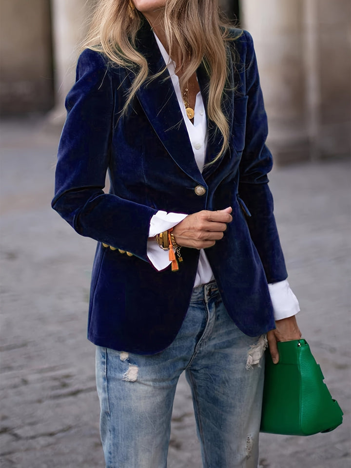 Professional women's tailored velvet blazer with opulent gold buttons, exuding sophisticated office wear.