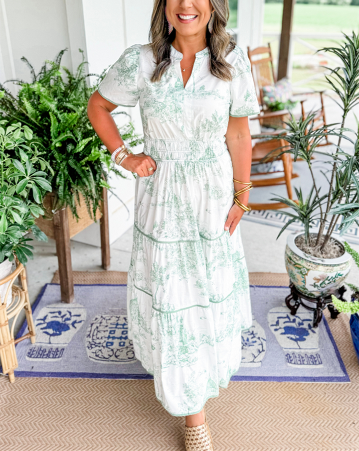 Chic women's toile print maxi dress featuring a smocked waist, V-neck, and tiered details. Long feminine style.