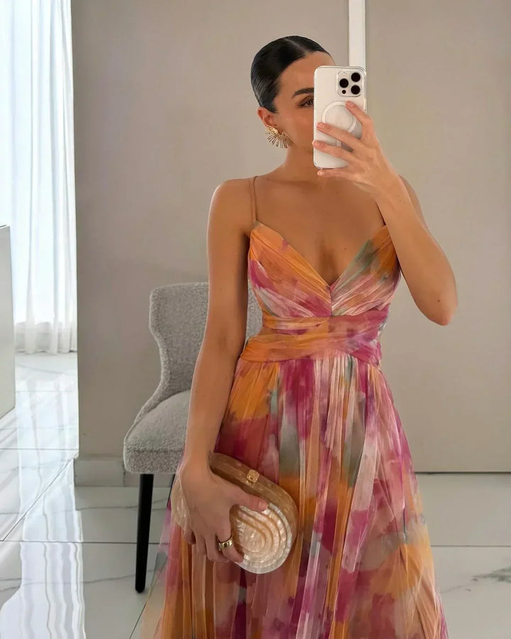 Flowy watercolor floral maxi dress for women, ideal for vacation, summer parties, or elegant occasion wear.