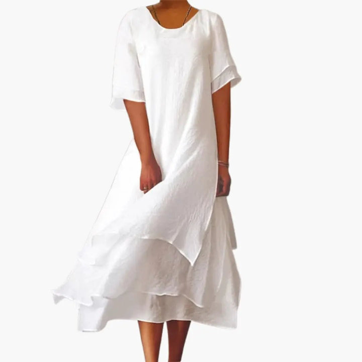 Elegant women's white sleeveless midi dress with a round neck, perfect for summer casual or everyday wear.
