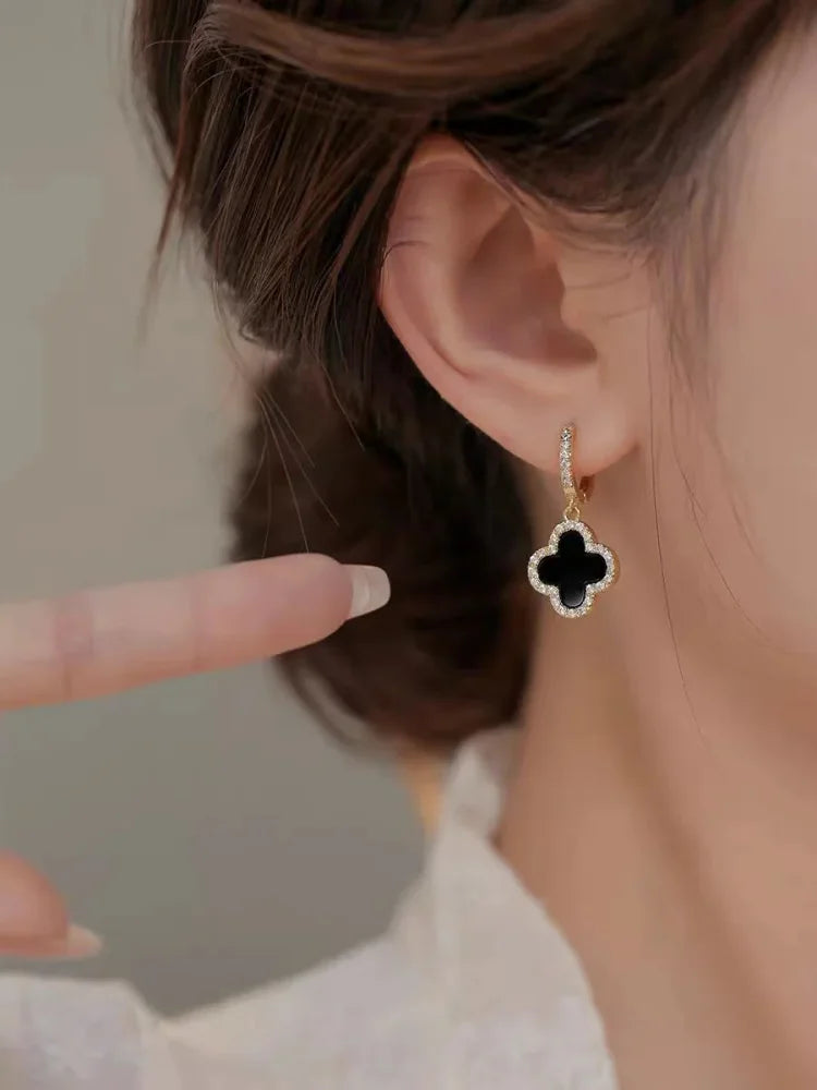 Elegante Kleeblatt-Ohrringe aus vergoldetem Silber in Rot, Grün, Schwarz: stilvolles Glückssymbol für modischen Schmuck.