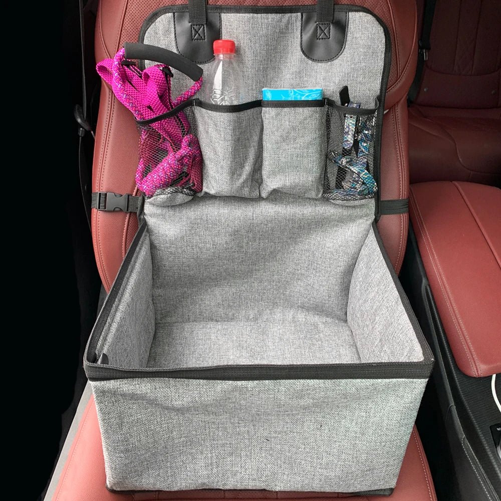 Small dog comfortably resting in an elevated pet booster seat with supportive walls and headrest in a car.