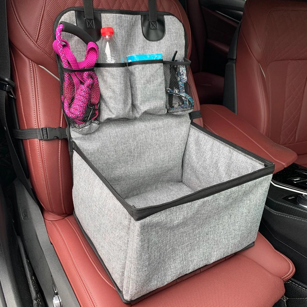 Detail view of the storage pocket on the side of an elevated dog car seat, perfect for pet accessories.