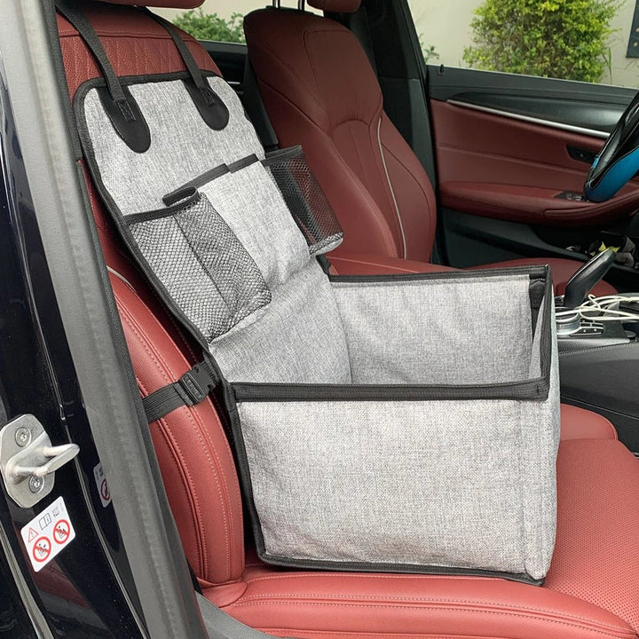 Top-down view of a durable elevated dog travel bed, showcasing the interior comfort and secure straps for car.