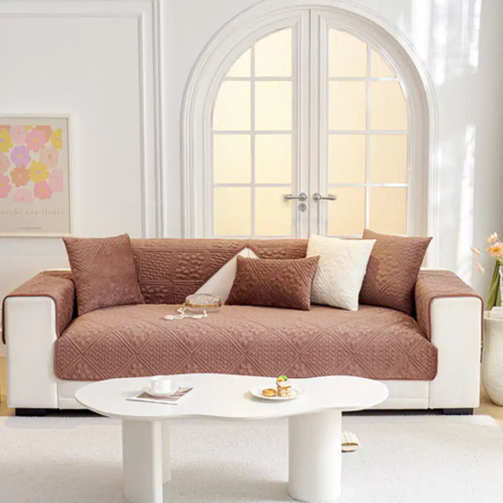 Dark grey plush sofa protector featuring an embossed geometric pattern, non-slip for active households.