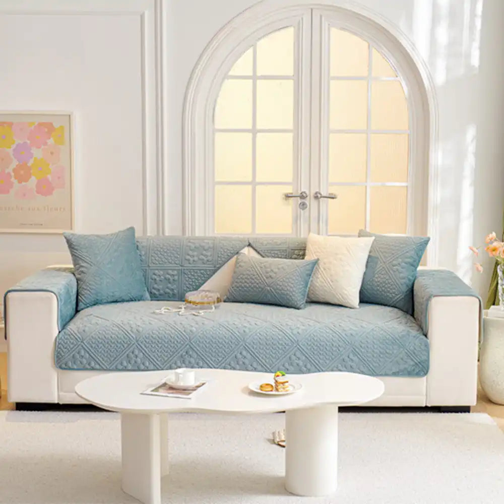 Soft plush quilted sofa cover with geometric pattern, offering durable and pet-friendly furniture protection.