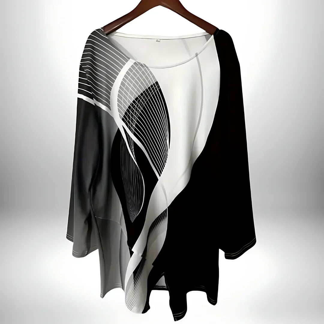 Geometrisches Langarm-Damentop in Schwarz-Weiß, asymmetrischer Saum, vielseitig kombinierbar für elegante und modische Looks.