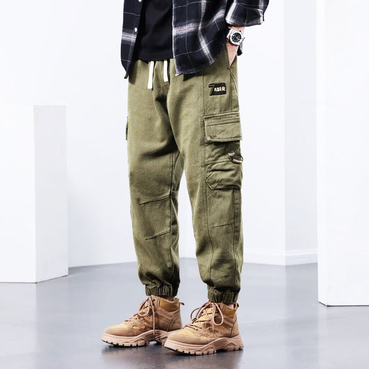 Black men's comfortable cargo pants with multi-pockets, ideal for stylish streetwear, workwear, or casual everyday outfits.
