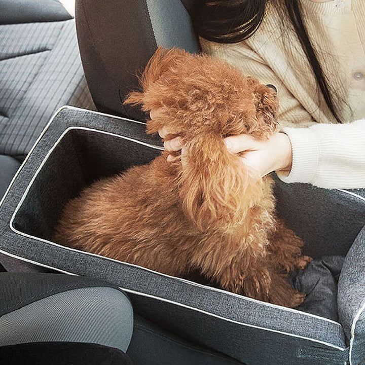 Empty grey suede square console car seat for small dogs, ready for travel