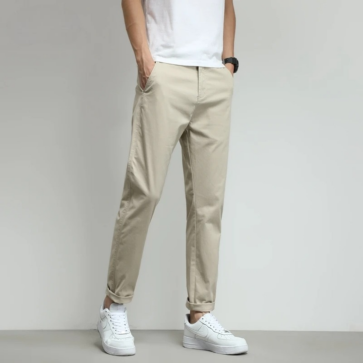 Beige men's casual slim-fit tech trousers. Comfortable and stylish for work, travel, or everyday wear.