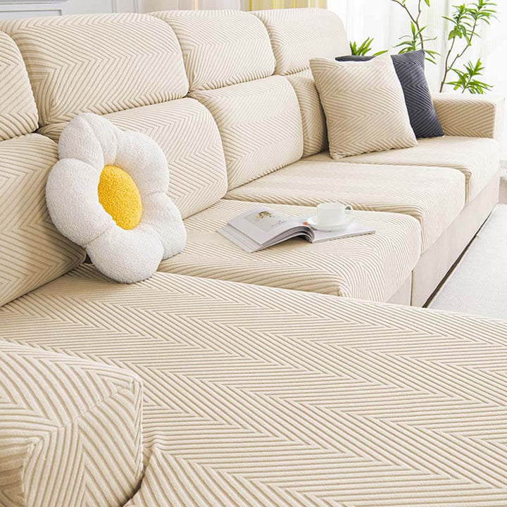 Stretchable pet-friendly herringbone chenille sofa cover in an entryway, protecting furniture
