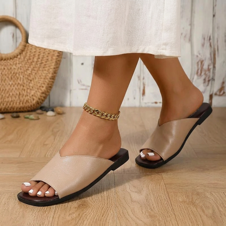 Close-up of the open-toe detail on women's fashionable summer flats, lightweight design.