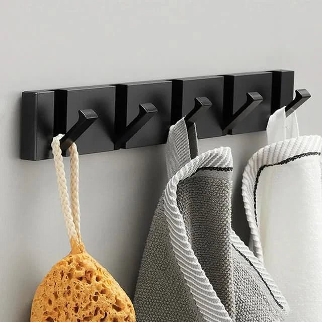 Kitchen folding wall hook for aprons, utensils. Modern aluminum, space-saving design for organization.