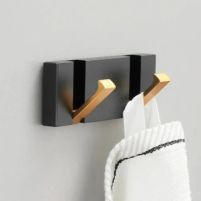 Sleek minimalist folding wall hook in aluminum. Ideal for modern home decor & organization.