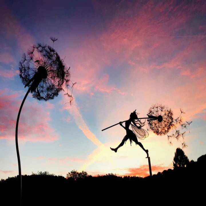 Enchanting metal fairy garden decor on a dandelion, a whimsical outdoor yard accent.