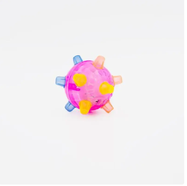 Close-up of a flashing pet play ball, an interactive dog toy with sound for active playtime