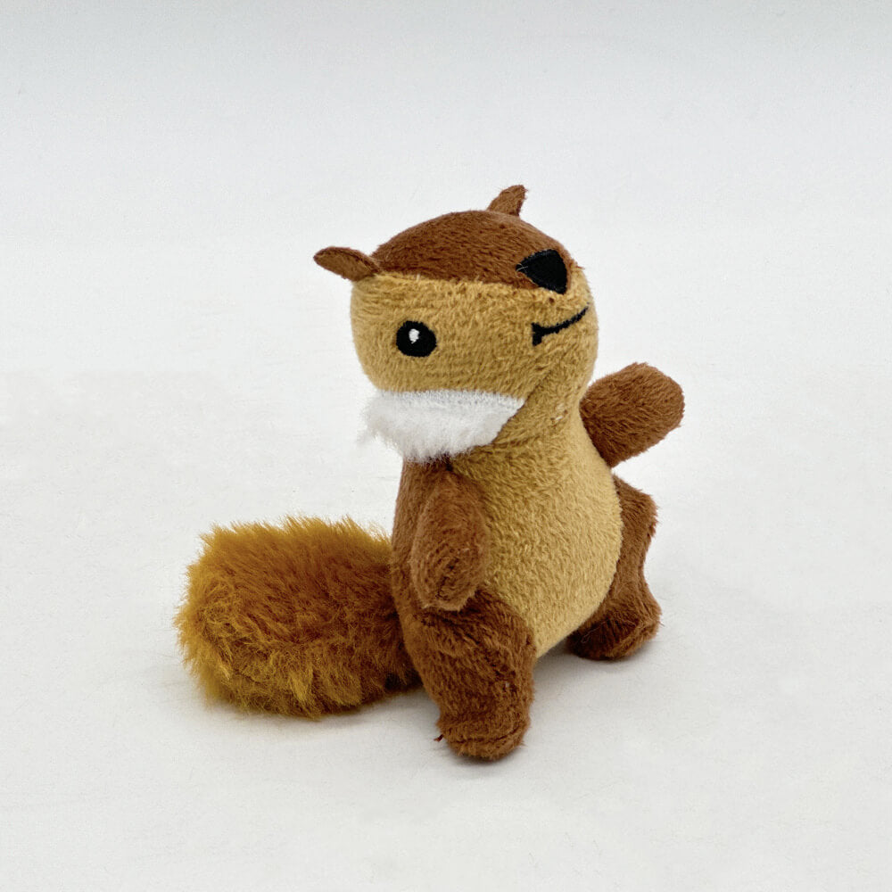 Six plush squeaky squirrels from an interactive dog puzzle toy with a brown tree trunk base