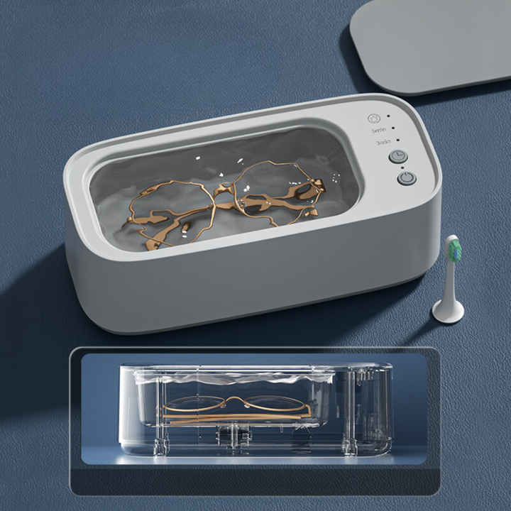 Kompaktes Ultraschallreinigungsgerät in Blau-Gelb für effektive Reinigung von Schmuck, Uhren und Brillen.