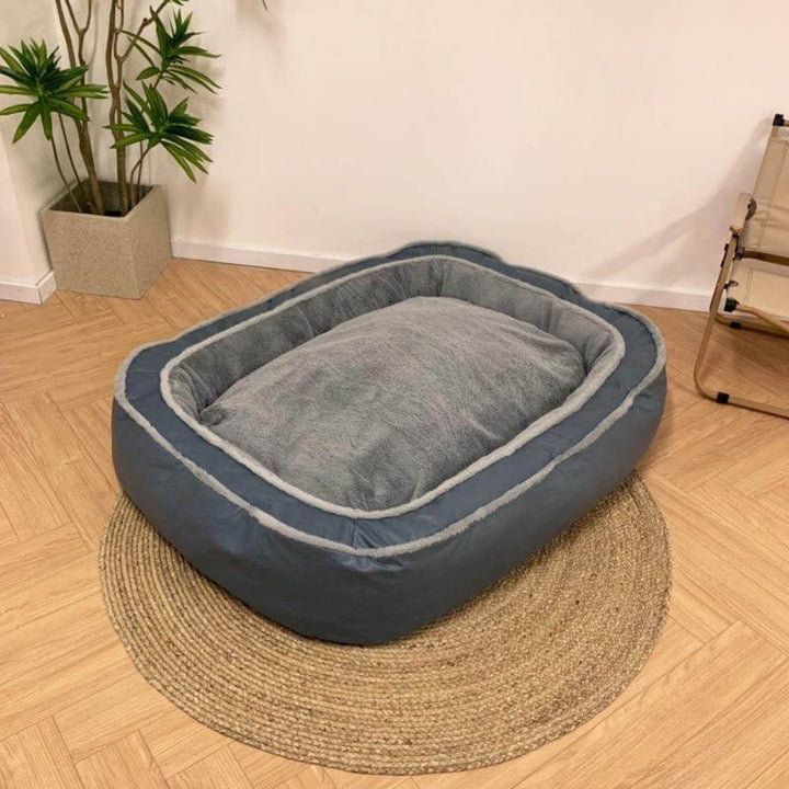 Large grey supportive dog bed for deep sleep and anxiety relief, plush and pressure-relieving.