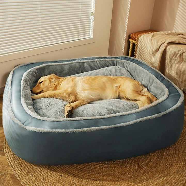 Soft grey dog bed with raised rim for head support and anxiety relief, ideal for deep sleep.