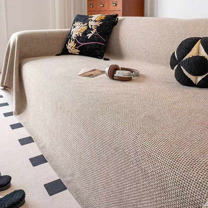 Reversible linen-look sofa cover draped on a couch, showing its pet-proof and breathable qualities